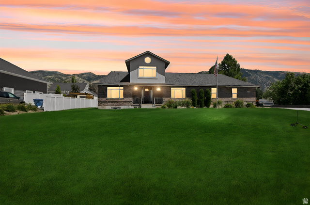 580 North 300 East Logan, UT 84321 - Photo 2 of 74 Contemporary residence featuring a brick and siding exterior, a prominent front gable, and a covered entry porch