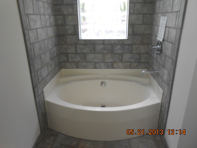 1512 Daly Road Wheaton, IL 60187 - Photo 17 of 20 a white bath tub sitting in a bathroom