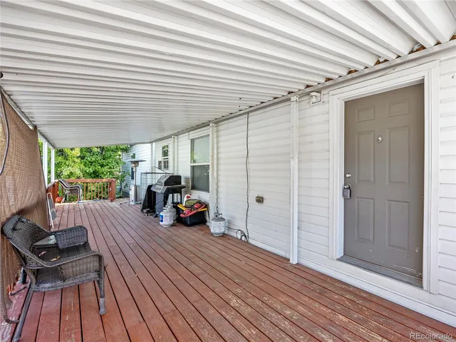 a view of a patio with table and chairs and wooden floor