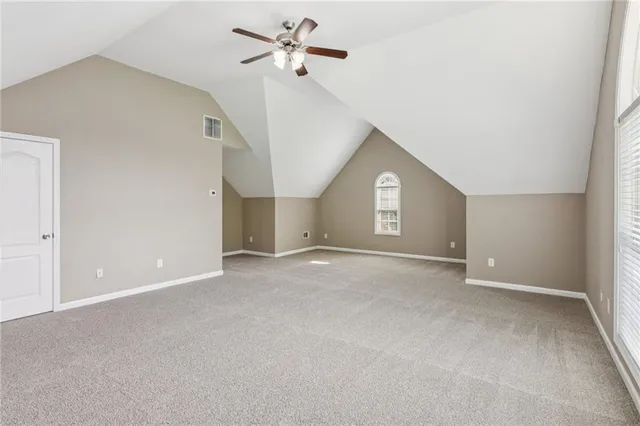 a view of a big room with a ceiling fan and entryway