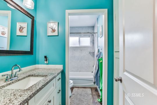700 Sherri Street Ridgecrest, CA 93555 - Photo 21 of 34 a bathroom with a granite countertop sink and a mirror