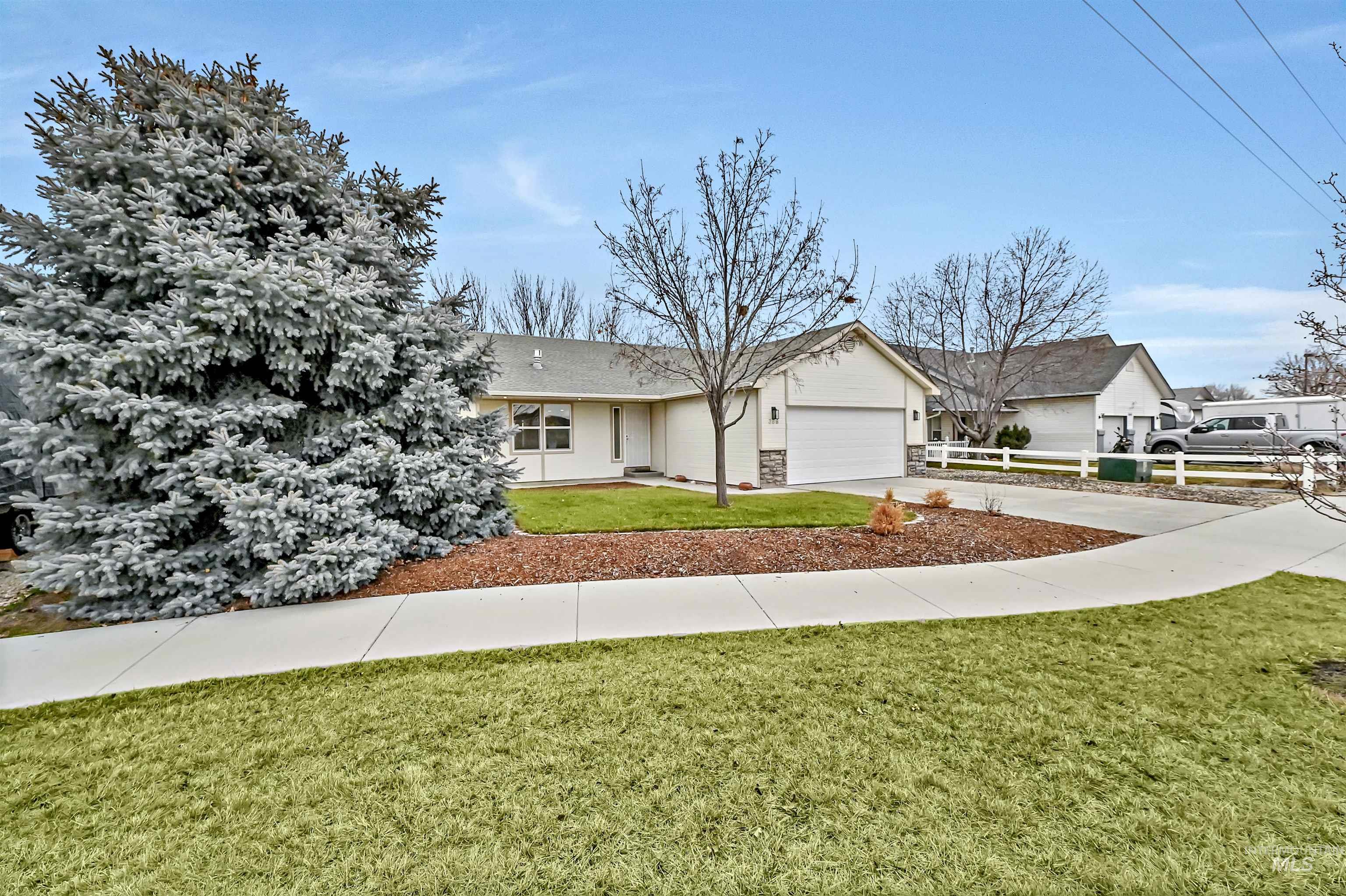 366 West Harris Street Meridian, ID 83642 - Photo 2 of 31 Single story home featuring driveway, an attached garage, stone siding, and roof with shingles
