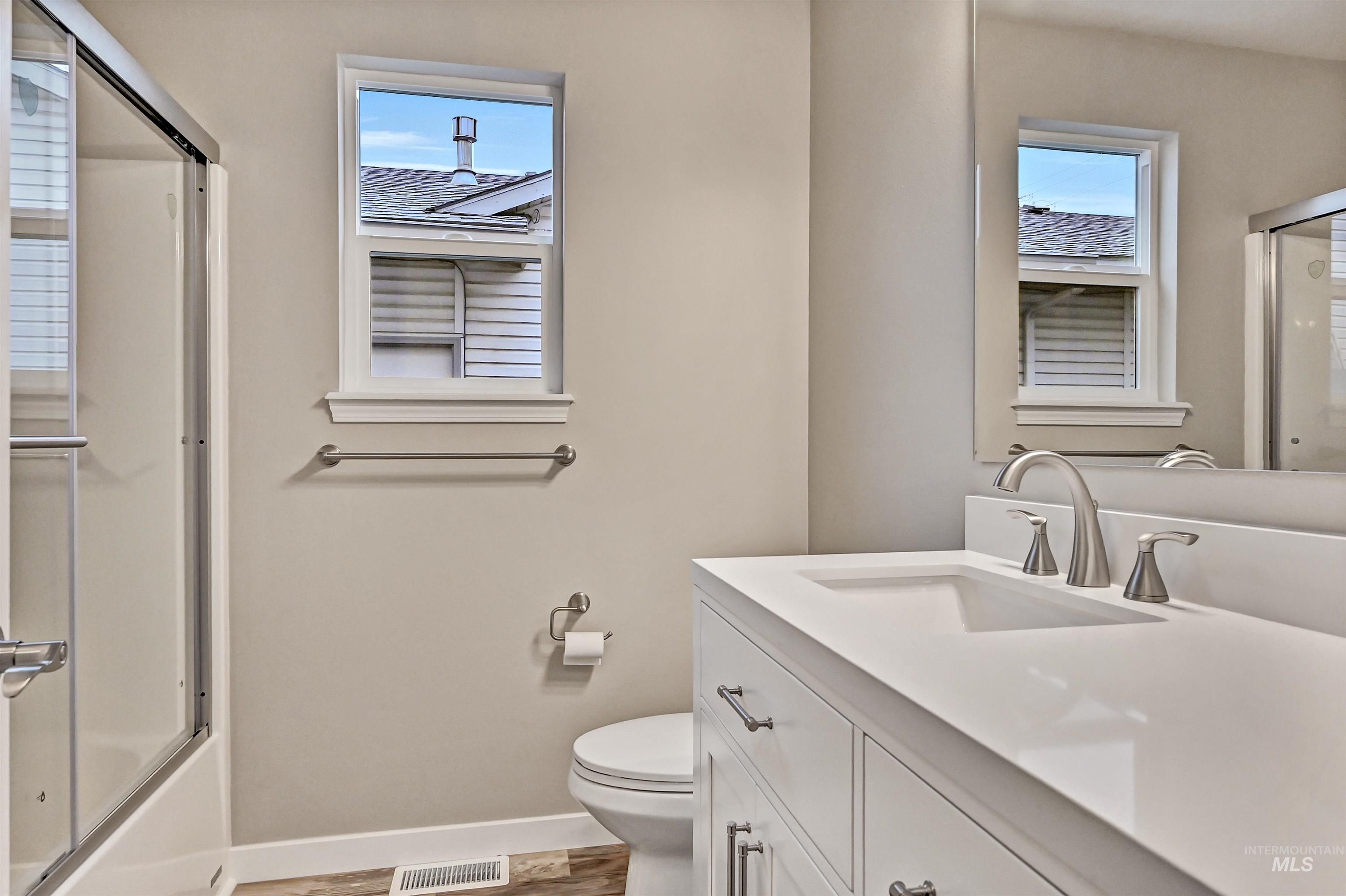 366 West Harris Street Meridian, ID 83642 - Photo 21 of 31 Full bath featuring vanity, shower / bath combination with glass door, and light wood-style flooring