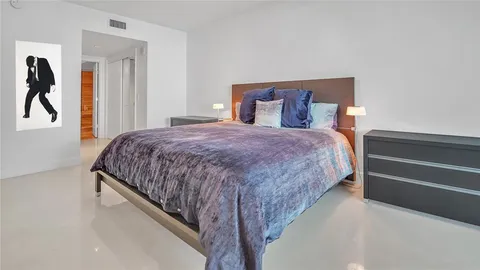 a bed room with furniture and a flat screen tv
