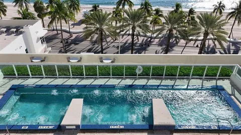 a view of a bathroom with tub and shower