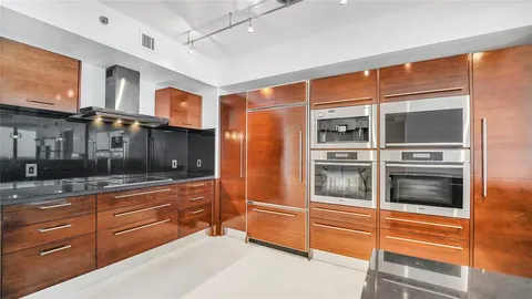 a kitchen with stainless steel appliances and cabinets