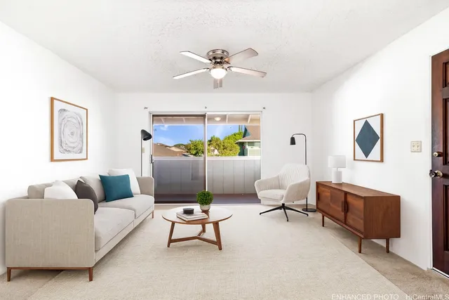 a living room with furniture and a ceiling fan