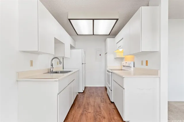 a kitchen with a sink a counter top space and cabinets