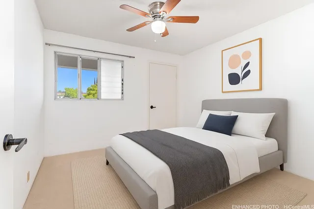 a bedroom with a bed and a painting on the wall