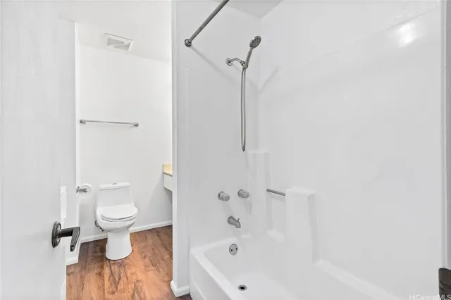 a bathroom with a bathtub and a toilet