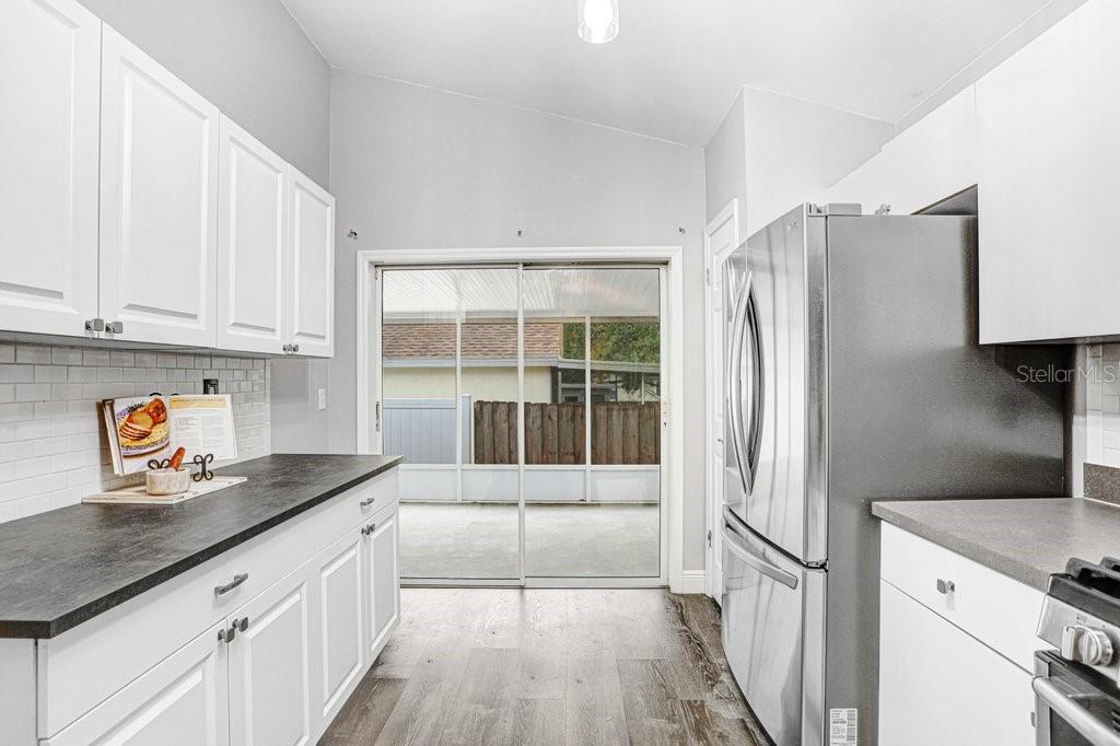 807 Cape Cod Circle Valrico, FL 33594 - Photo 12 of 26 a kitchen with stainless steel appliances granite countertop a refrigerator and a sink