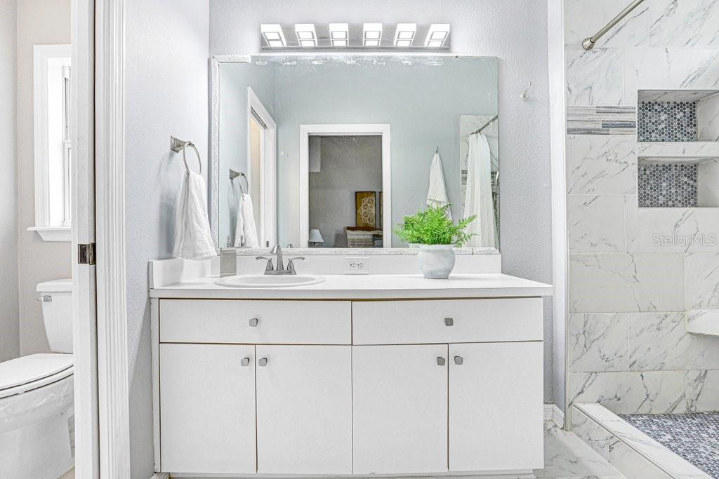 807 Cape Cod Circle Valrico, FL 33594 - Photo 16 of 26 a bathroom with a granite countertop sink and a mirror