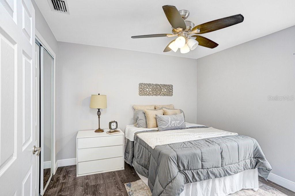 807 Cape Cod Circle Valrico, FL 33594 - Photo 22 of 26 a bedroom with a large bed and a ceiling fan