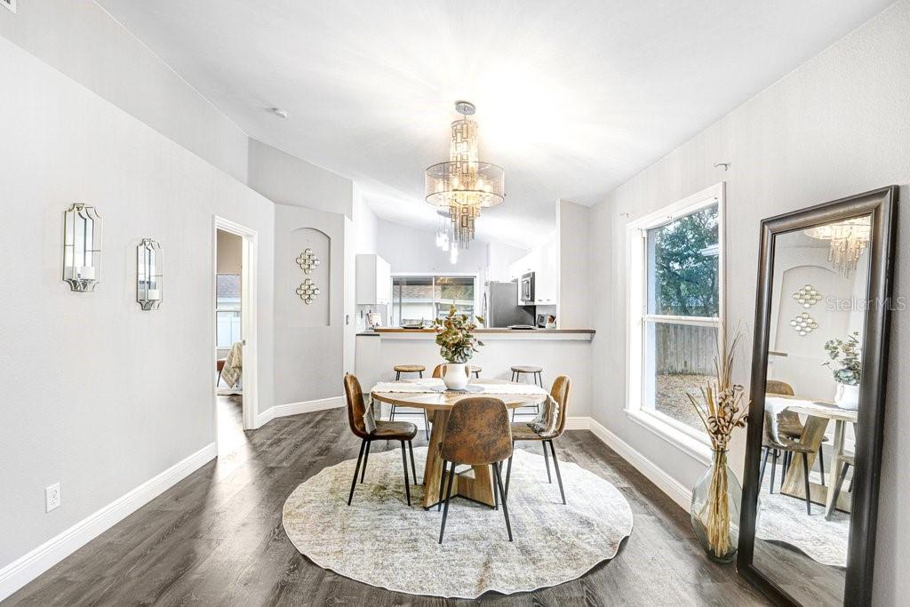 807 Cape Cod Circle Valrico, FL 33594 - Photo 8 of 26 a view of a dining room with furniture window and wooden floor