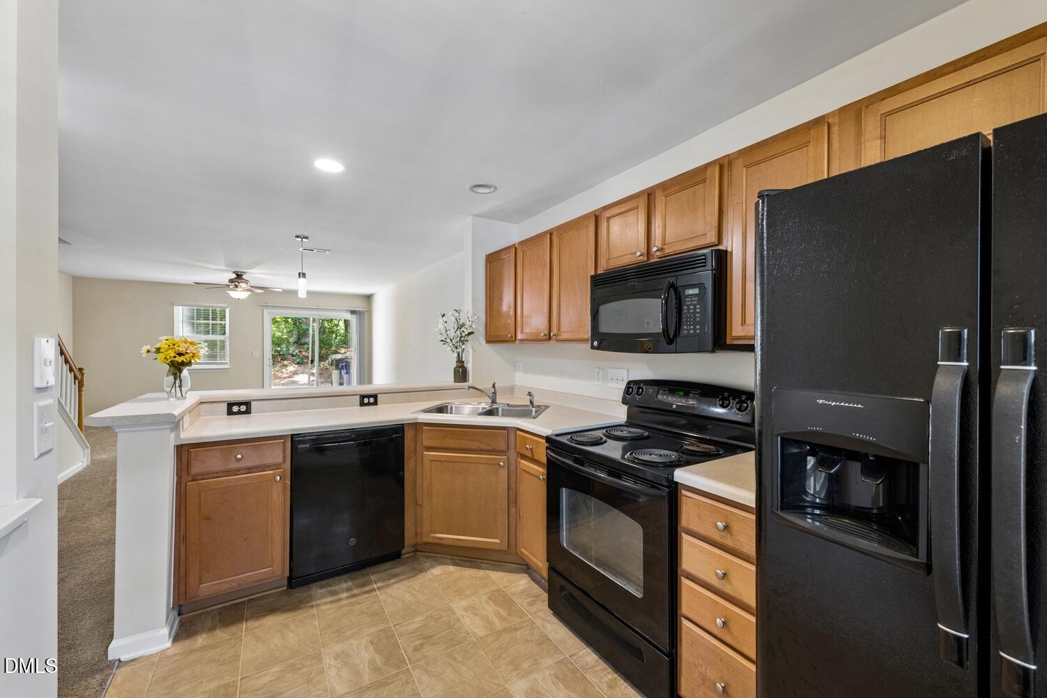 3635 Bison Hill Lane Raleigh, NC 27604 - Photo 7 of 18 a kitchen with stainless steel appliances granite countertop a sink stove and refrigerator