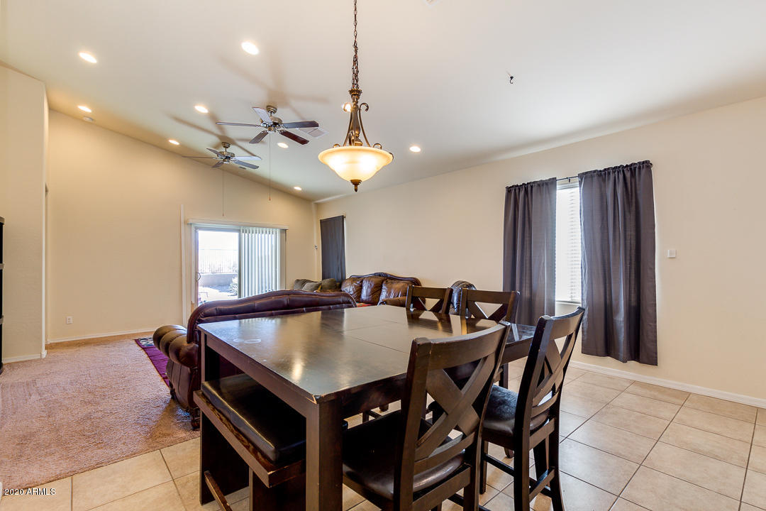 7615 West Carter Road Laveen, AZ 85339 - Photo 13 of 34 a view of a dining room with furniture and chandelier