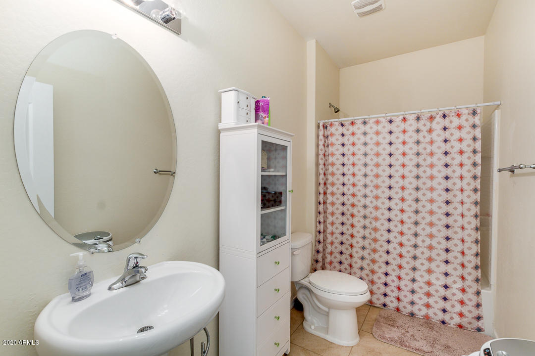 7615 West Carter Road Laveen, AZ 85339 - Photo 16 of 34 a bathroom with a sink toilet and shower