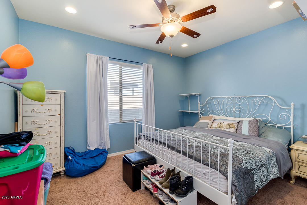 7615 West Carter Road Laveen, AZ 85339 - Photo 22 of 34 a bedroom with a bed and a chandelier