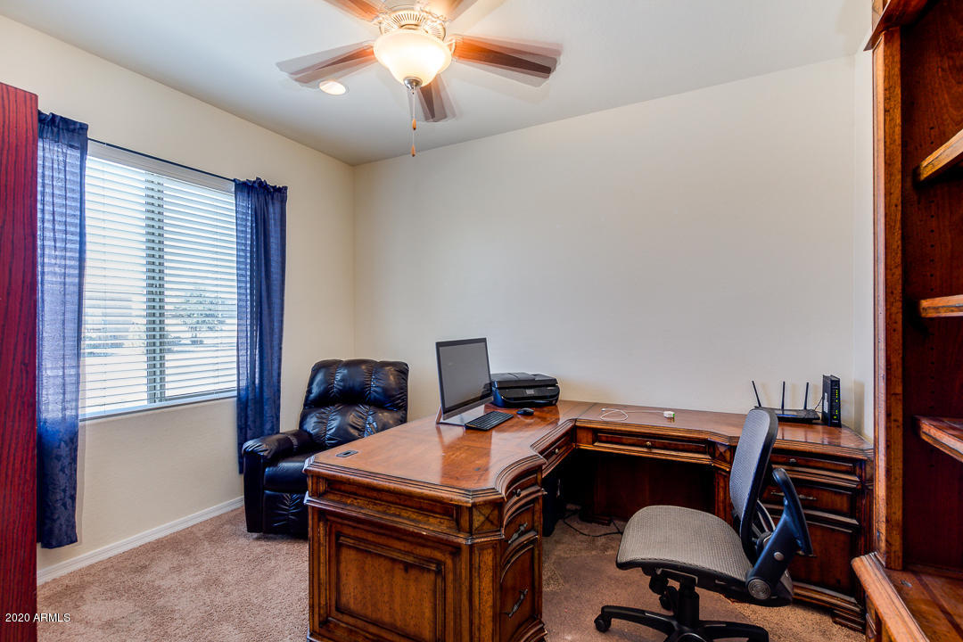 7615 West Carter Road Laveen, AZ 85339 - Photo 23 of 34 a view of a workspace with furniture and a window