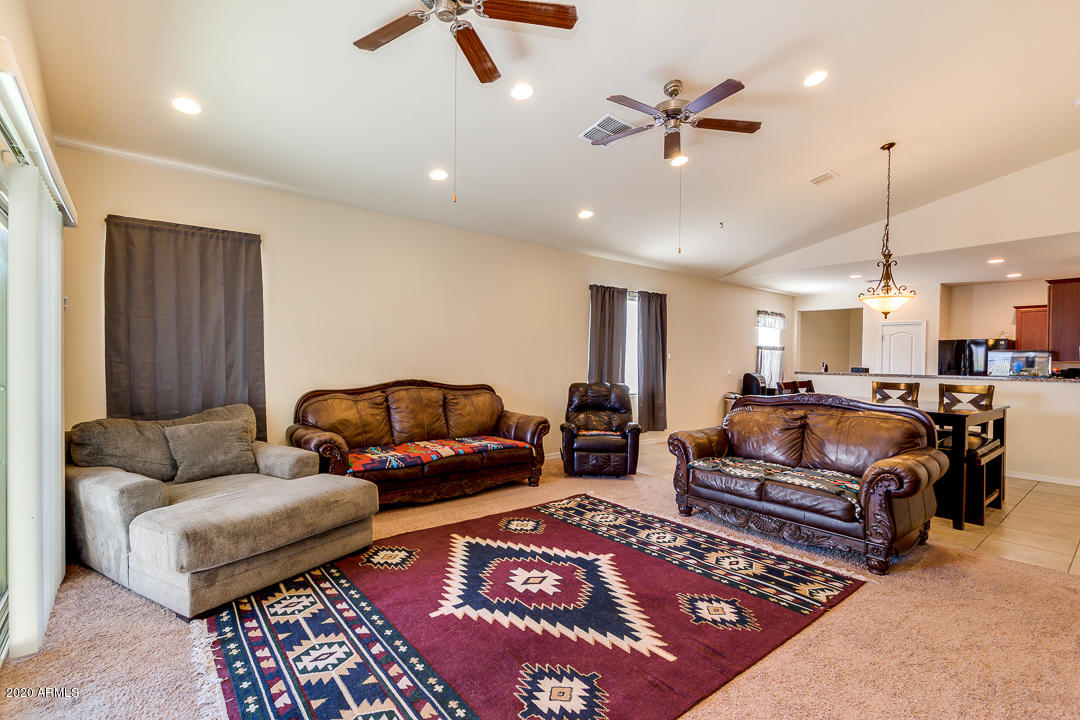 7615 West Carter Road Laveen, AZ 85339 - Photo 6 of 34 a living room with furniture ceiling fan and a rug