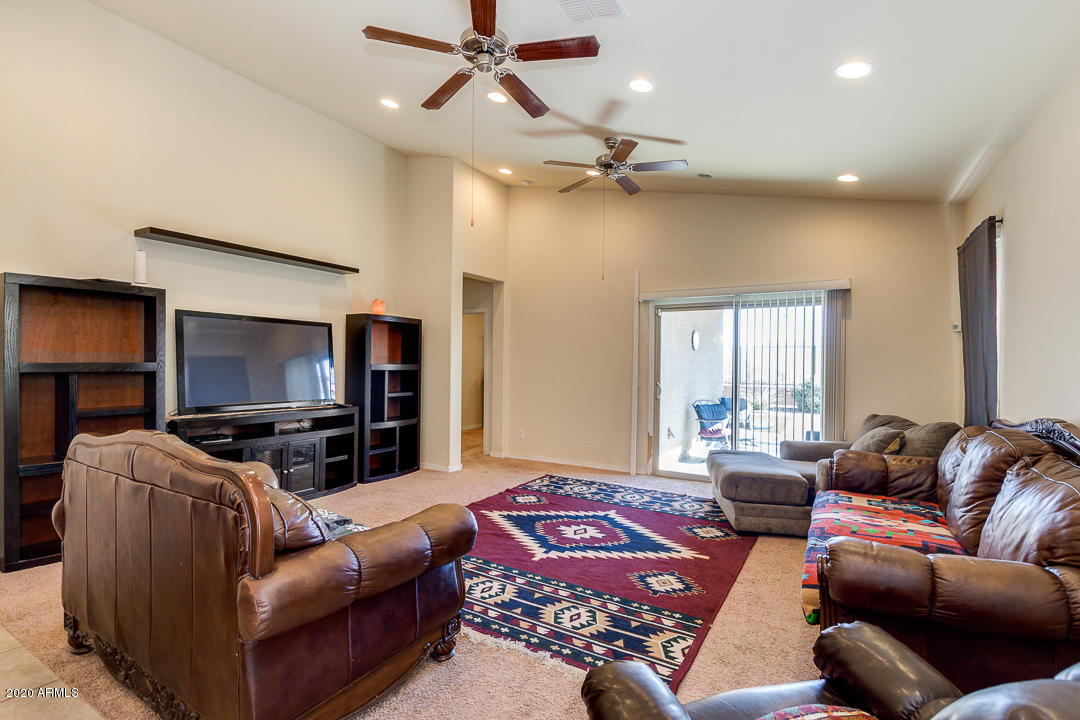 7615 West Carter Road Laveen, AZ 85339 - Photo 8 of 34 a living room with furniture and a flat screen tv