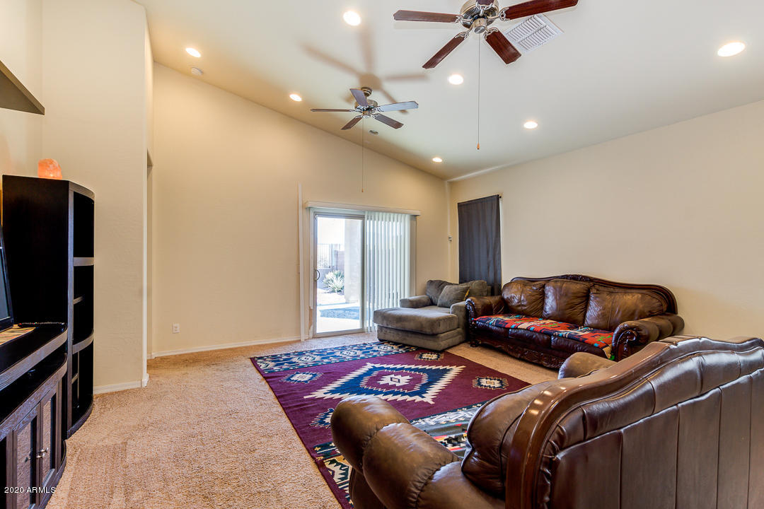 7615 West Carter Road Laveen, AZ 85339 - Photo 9 of 34 a living room with furniture and a flat screen tv