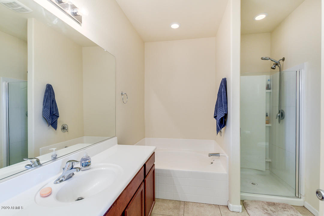7615 West Carter Road Laveen, AZ 85339 - Photo 10 of 34 a bathroom with a tub sink and mirror
