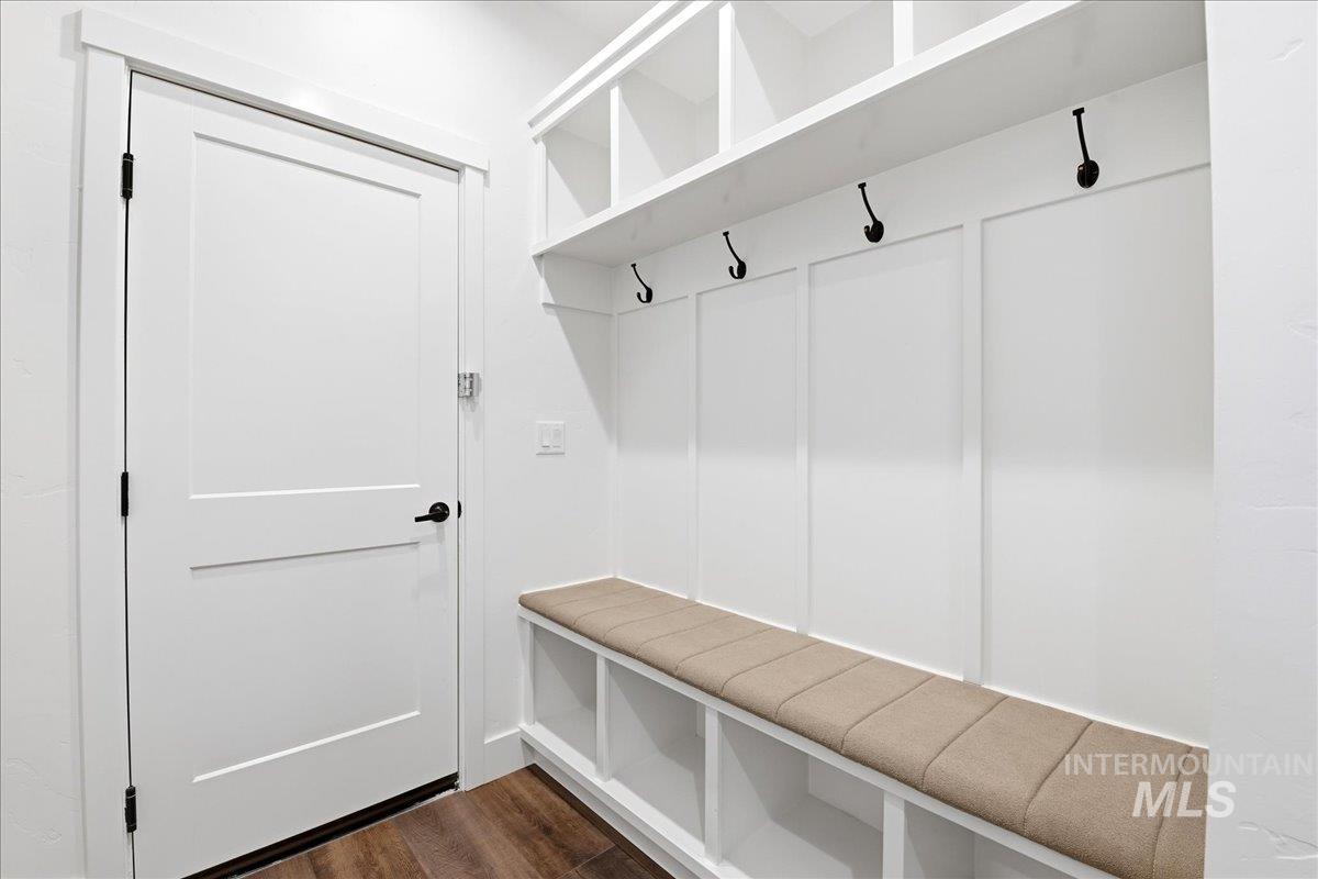 13152 Hawks Bay Road Donnelly, ID 83615 - Photo 23 of 29 Mudroom featuring built-in storage with upper shelving and lower cubbies, a padded bench, and wall-mounted hooks