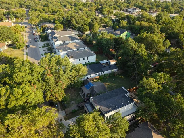 an aerial view of a house with a yard