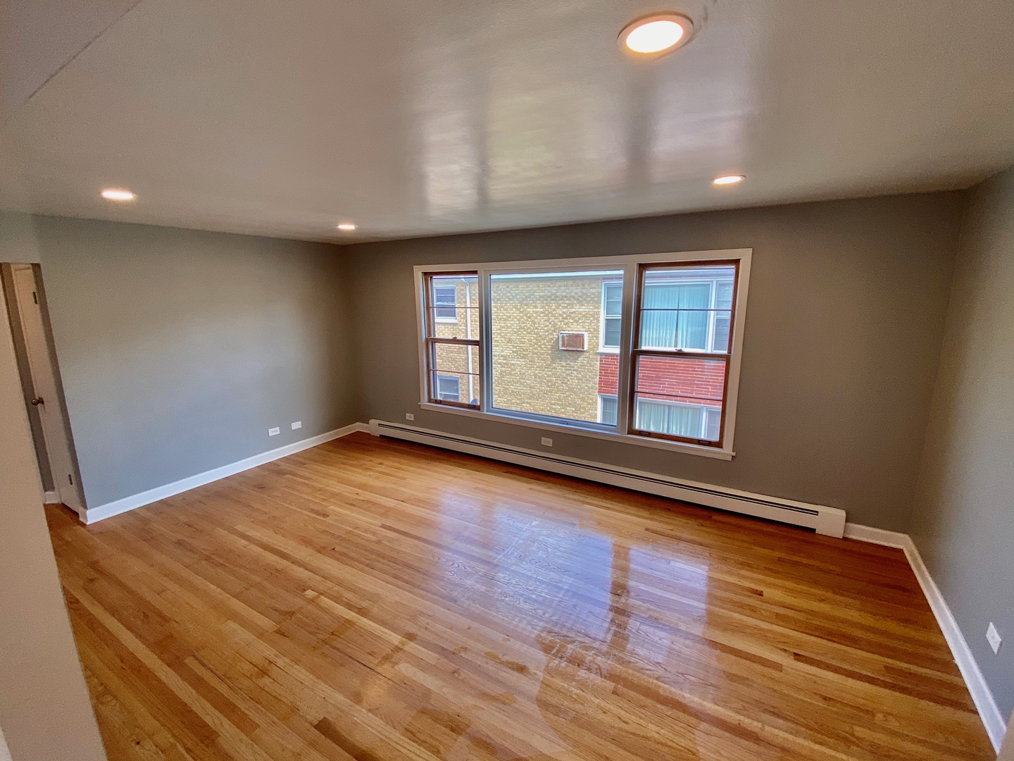2259 South 17th Avenue, Unit 2F North Riverside, IL 60546 - Photo 12 of 12 an empty room with wooden floor and windows