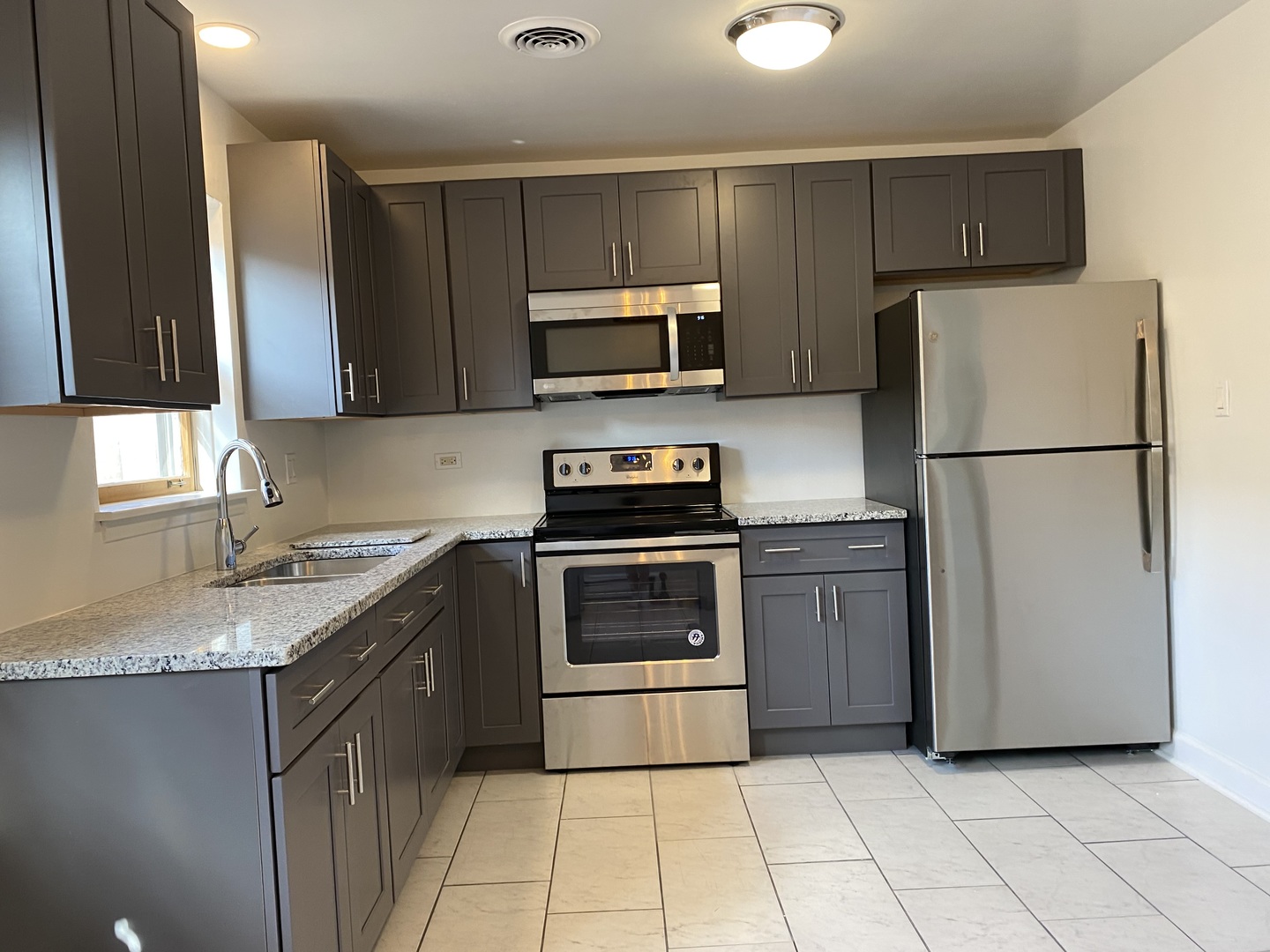 2259 South 17th Avenue, Unit 2F North Riverside, IL 60546 - Photo 2 of 12 a kitchen with a refrigerator sink and microwave