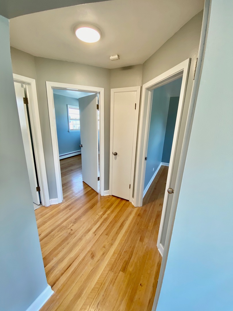 2259 South 17th Avenue, Unit 2F North Riverside, IL 60546 - Photo 7 of 12 a view of a hallway with wooden floor and cabinet