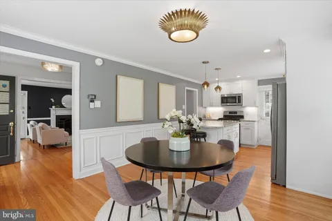 a kitchen with a dining table and chairs