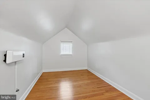a view of a livingroom with wooden floor and a window