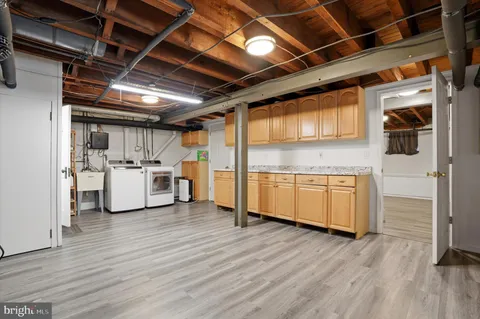 a utility room with wooden floor