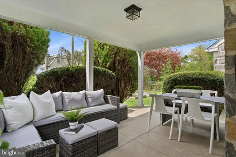 a balcony with furniture and a floor to ceiling window
