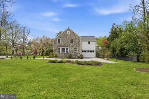 a view of a big yard with a house in the background