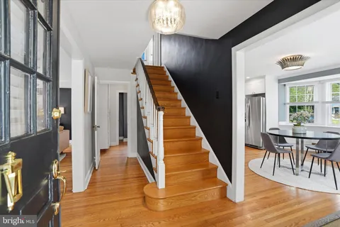 a view of a hallway with wooden floor and staircase