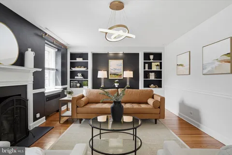 a living room with furniture a rug and a fireplace