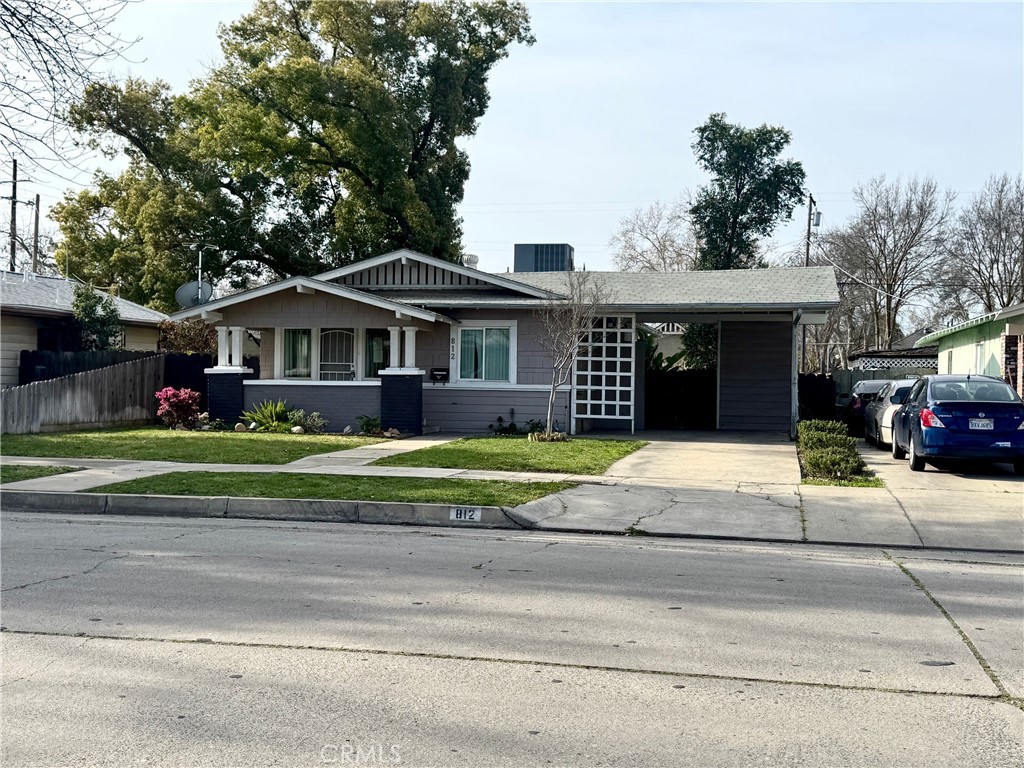812 West 23rd Street Merced, CA 95340 - Photo 1 of 1 a front view of a house with a garden and trees