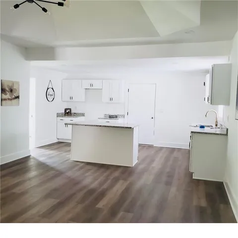 a view with cabinets potted plant and wooden floor