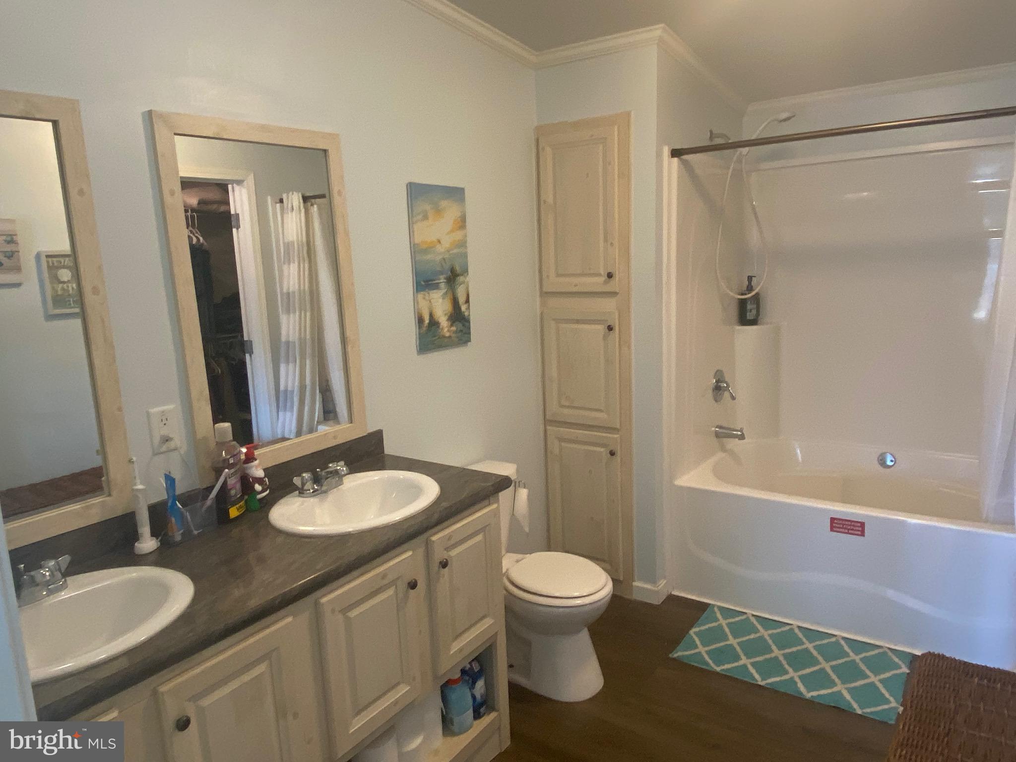 9415 Cherry Tree Lane Seaford, DE 19973 - Photo 21 of 43 a bathroom with a granite countertop sink toilet a mirror and shower
