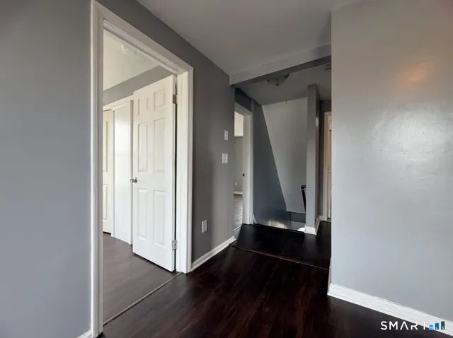 an entryway door with wooden floor