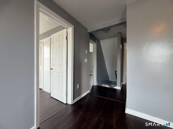 an entryway door with wooden floor