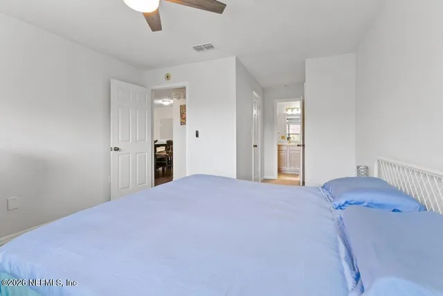 a bathroom with a sink a toilet a large mirror and shower