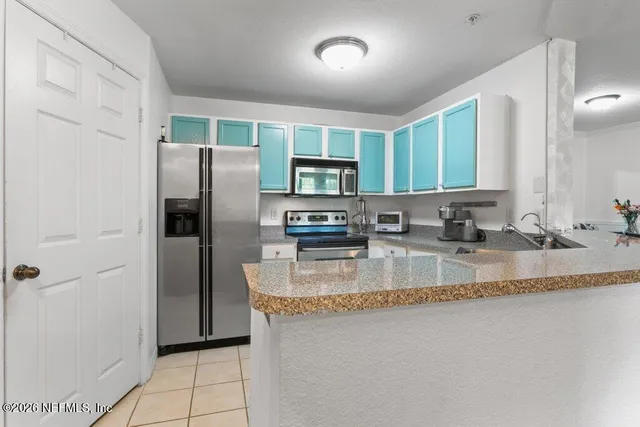 a living room with furniture and view of kitchen
