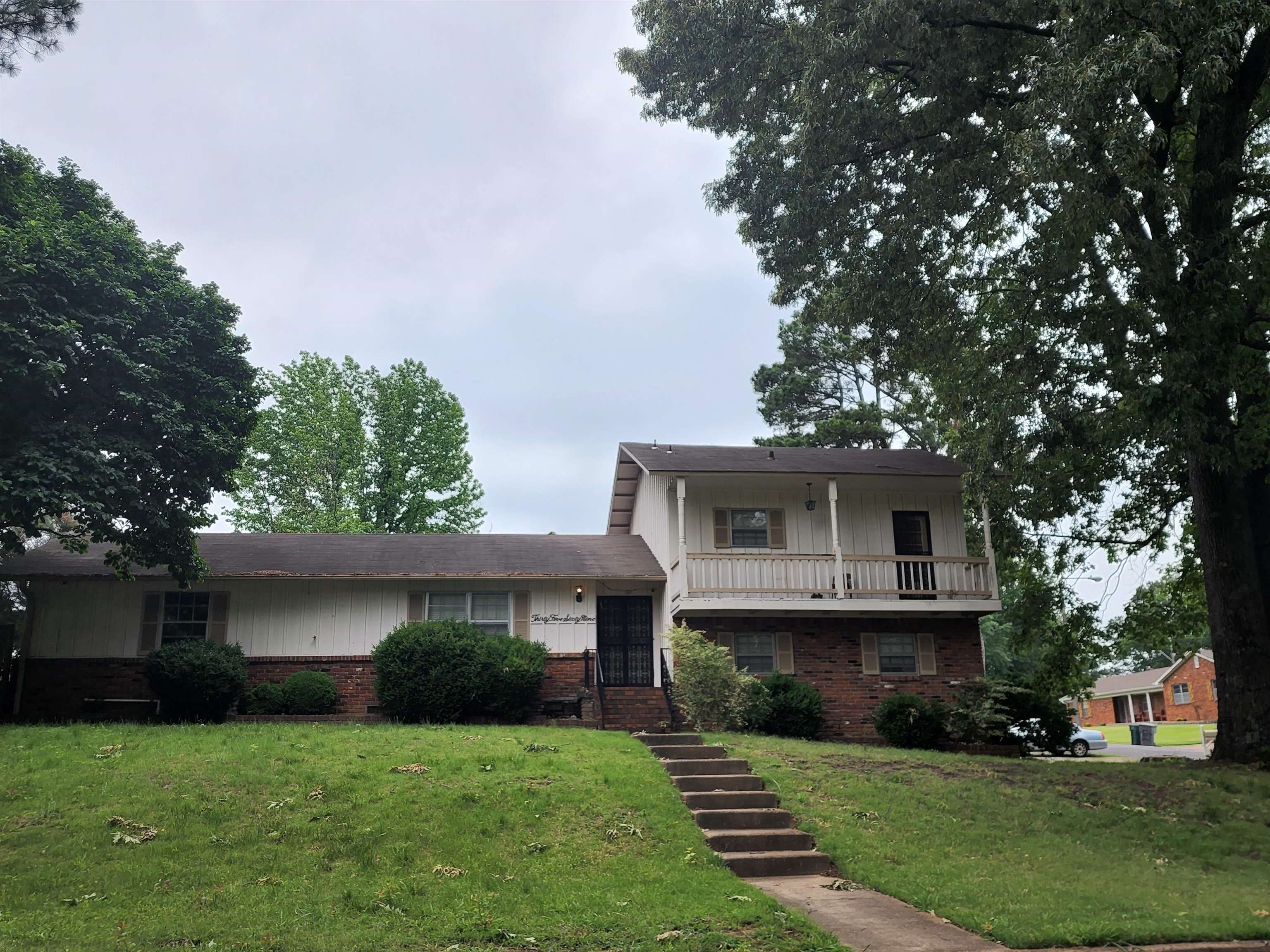 3569 Arsenal Street Memphis, TN 38128 - Photo 2 of 3 a front view of a house with a yard and trees