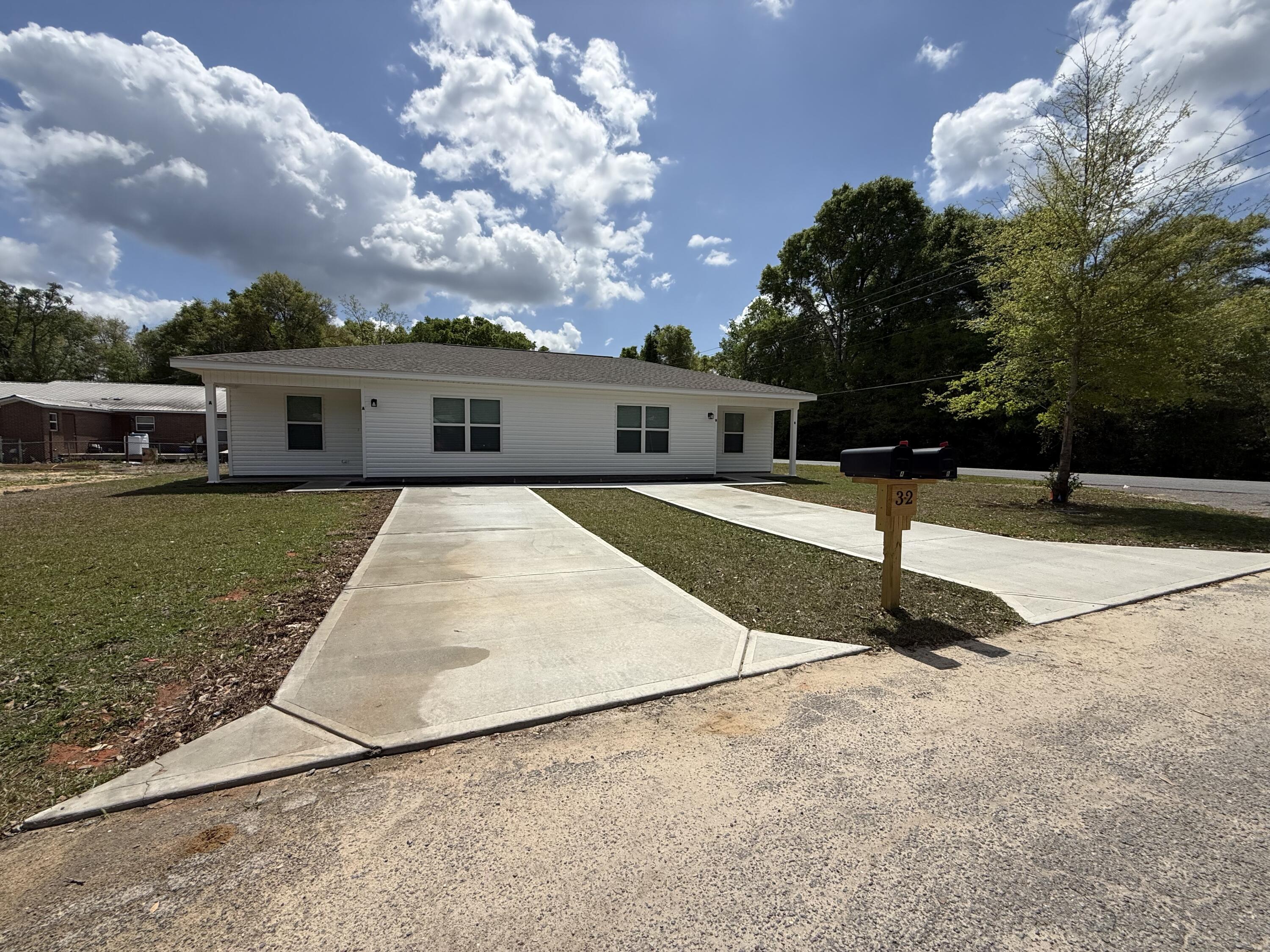 32 Constitution Avenue, Unit AB DeFuniak Springs, FL 32433 - Photo 1 of 22 a view of a house with sitting area and yard