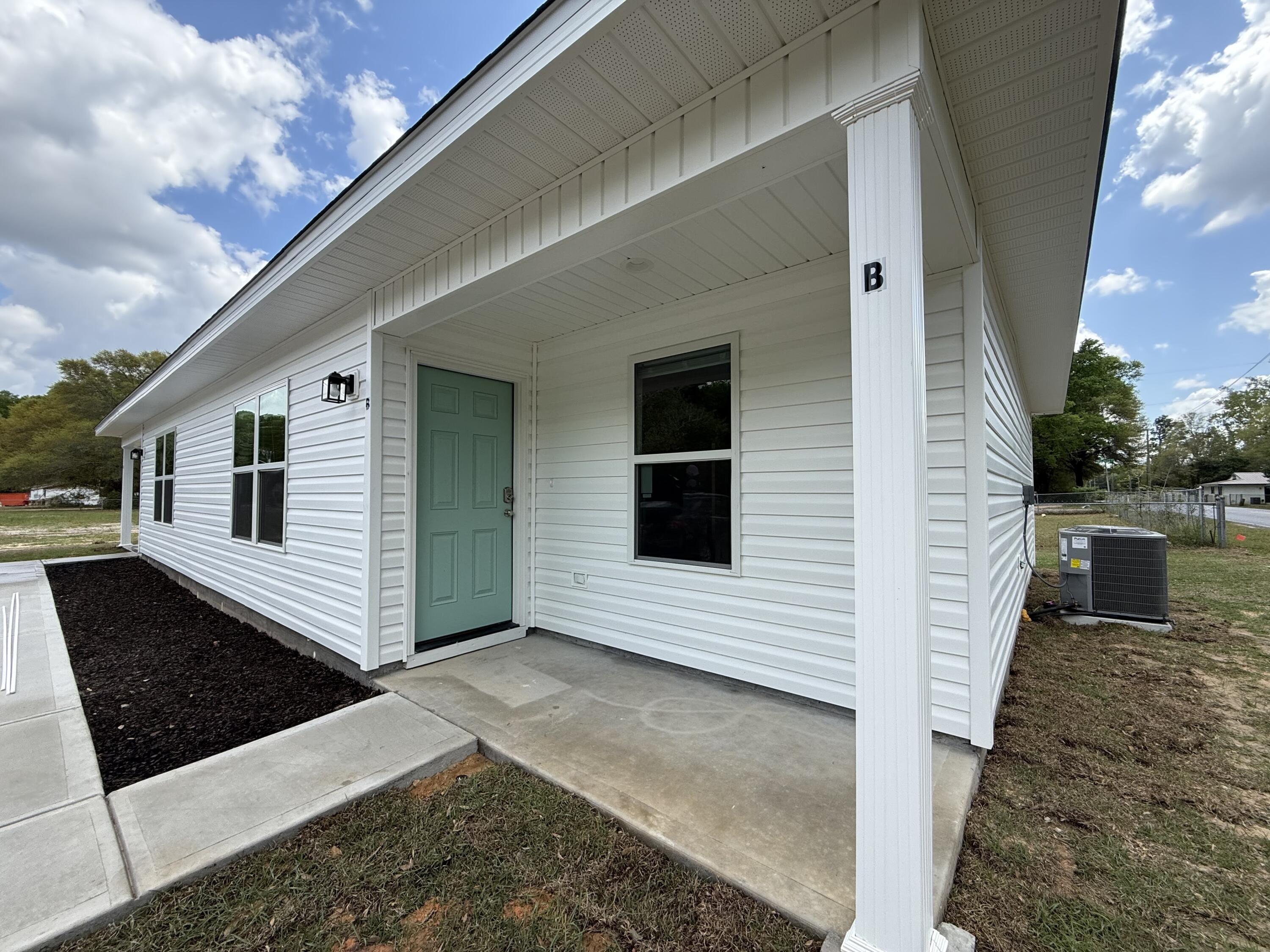 32 Constitution Avenue, Unit AB DeFuniak Springs, FL 32433 - Photo 2 of 22 a view of a back yard of the house