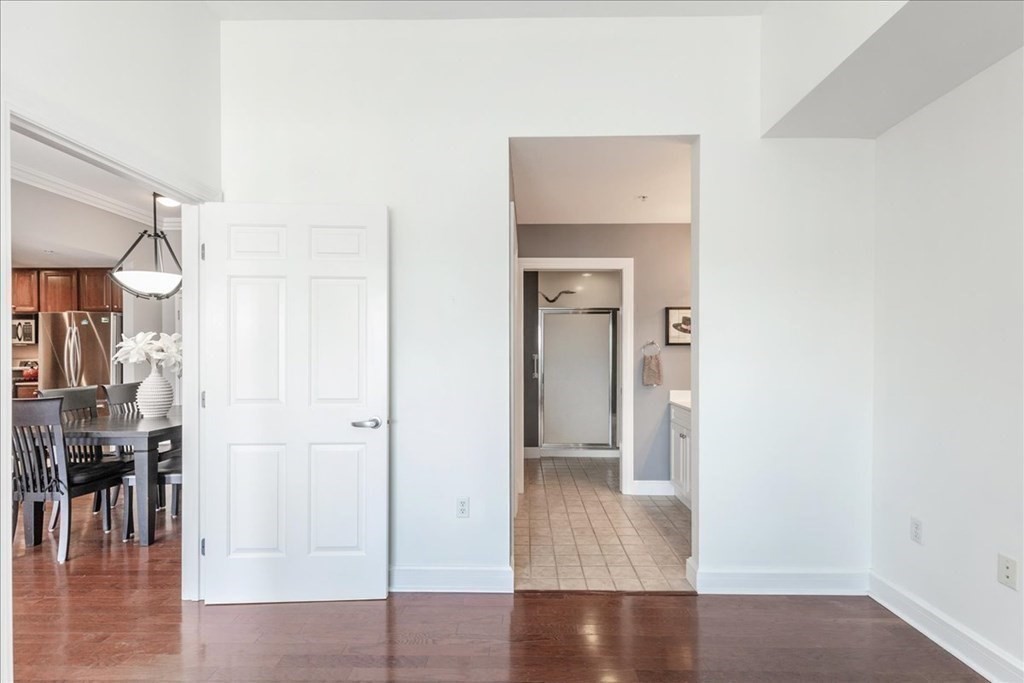 36 Village Road, Unit 706 Middleton, MA 01949 - Photo 29 of 42 a view of a hallway with wooden floor and a bathroom